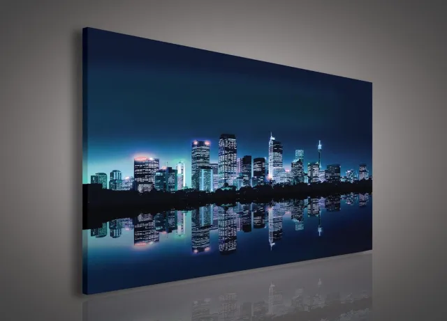 Canvas Schilderij - New York - Stad - Lichten - Skyline - Toren - Blauw - Gebouw - Schilderij Woonkamer - Schilderijen op canvas - Inclusief Frame - 100x75cm (LxB) Oranje